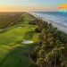 Aerial sunrise view of championship golf course in Myrtle Beach showing pristine fairways, greens, and coastal backdrop - complete guide to Grand Strand golf courses