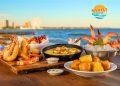Myrtle Beach signature dishes including calabash fried shrimp, shrimp and grits, seafood boil, and hushpuppies arranged on coastal table