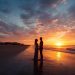 Couple watching romantic sunrise over Myrtle Beach with SkyWheel in background